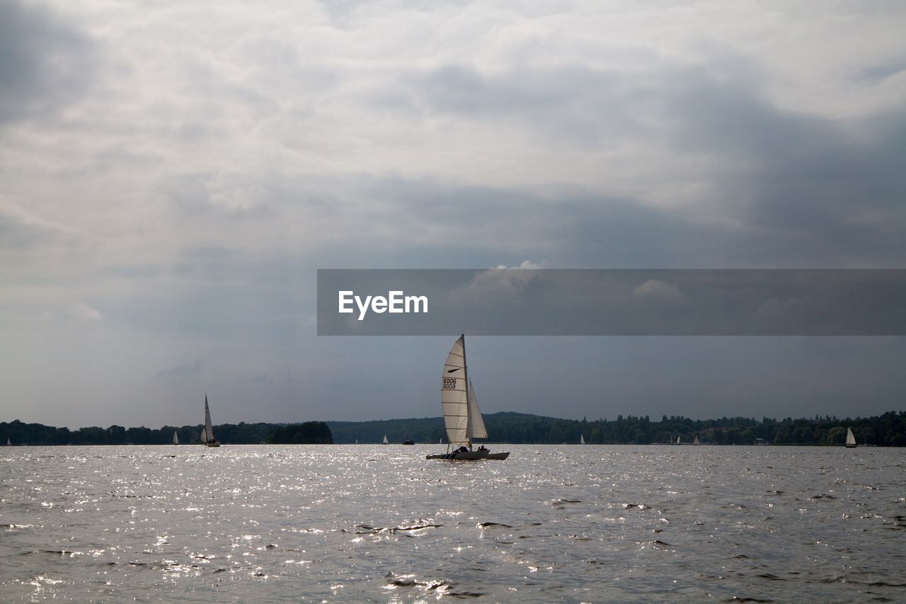 Sailboats against sky in sea