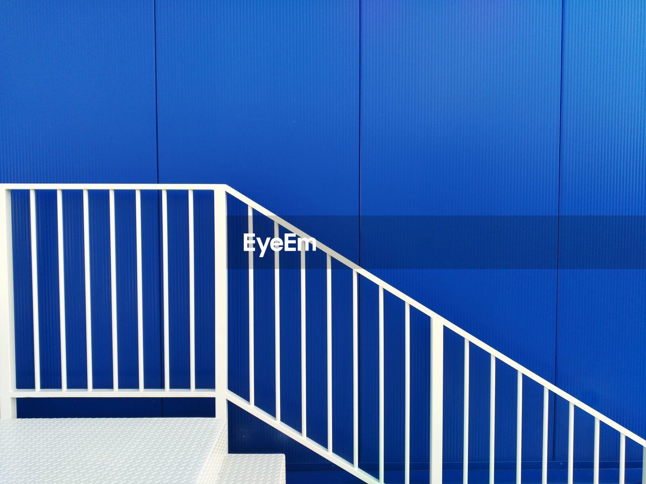 Close-up of metallic structure against blue wall