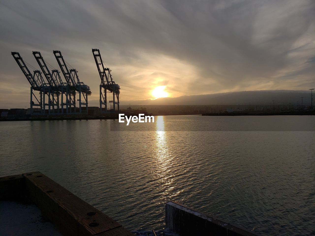 PIER OVER SEA AGAINST SUNSET SKY