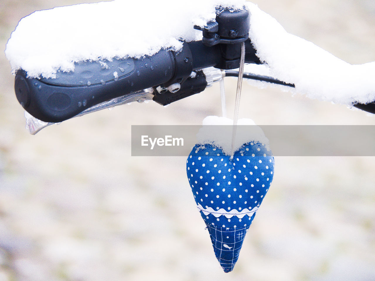 CLOSE-UP OF HEART SHAPE HANGING ON SNOW COVERED LANDSCAPE