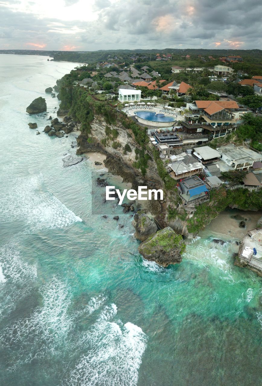 HIGH ANGLE VIEW OF HOUSES BY SEA AND BUILDINGS