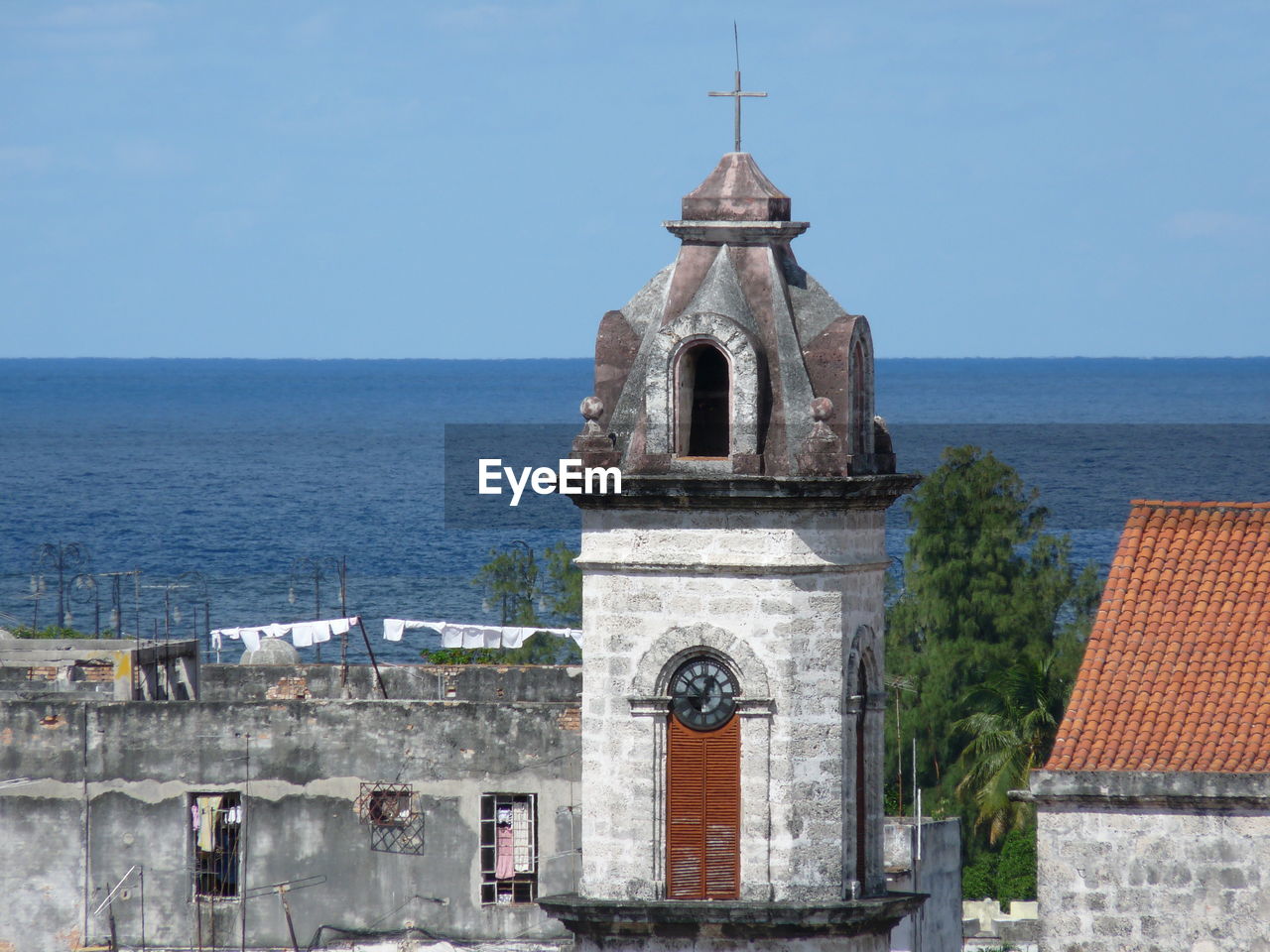 Church by sea against clear sky