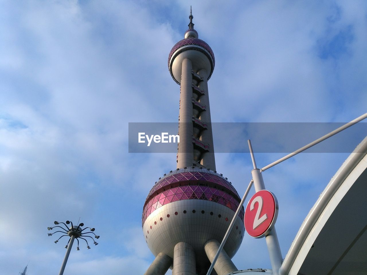 LOW ANGLE VIEW OF COMMUNICATIONS TOWER AGAINST CLOUDY SKY