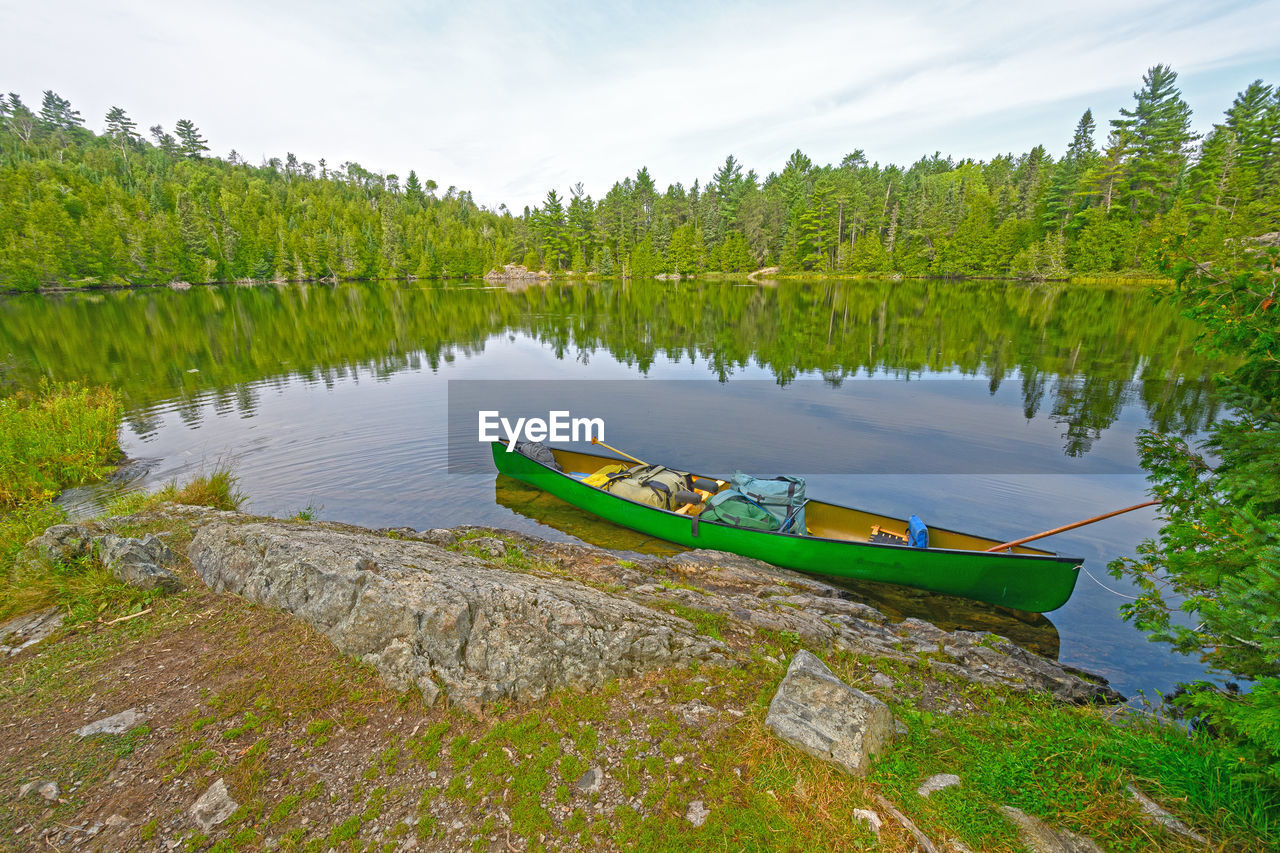 Canoe on the wilderness shore of ottertrack lake in the boudnary waters of minnesota