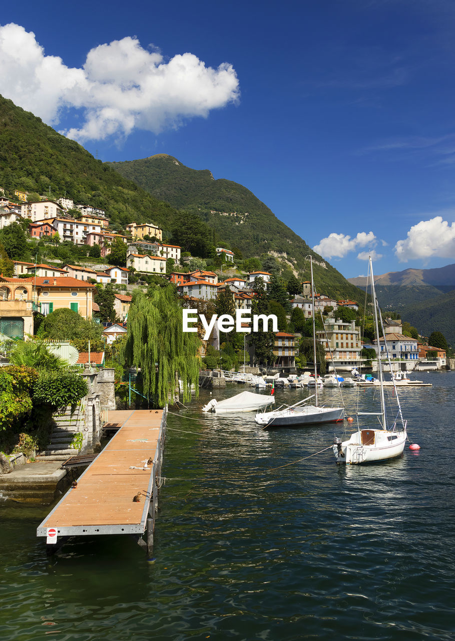 Boats in river against built structures