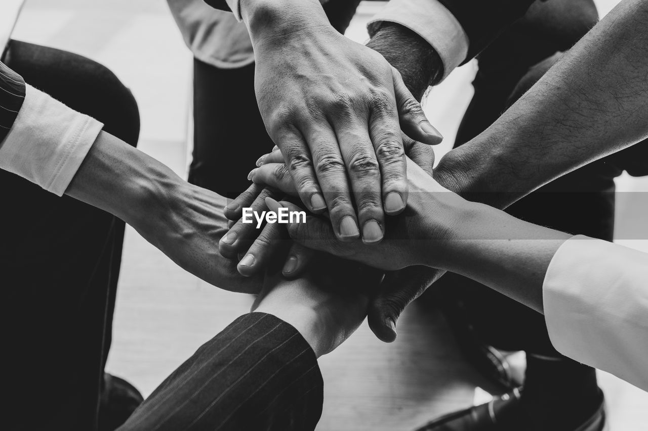 Group of people stacking hands