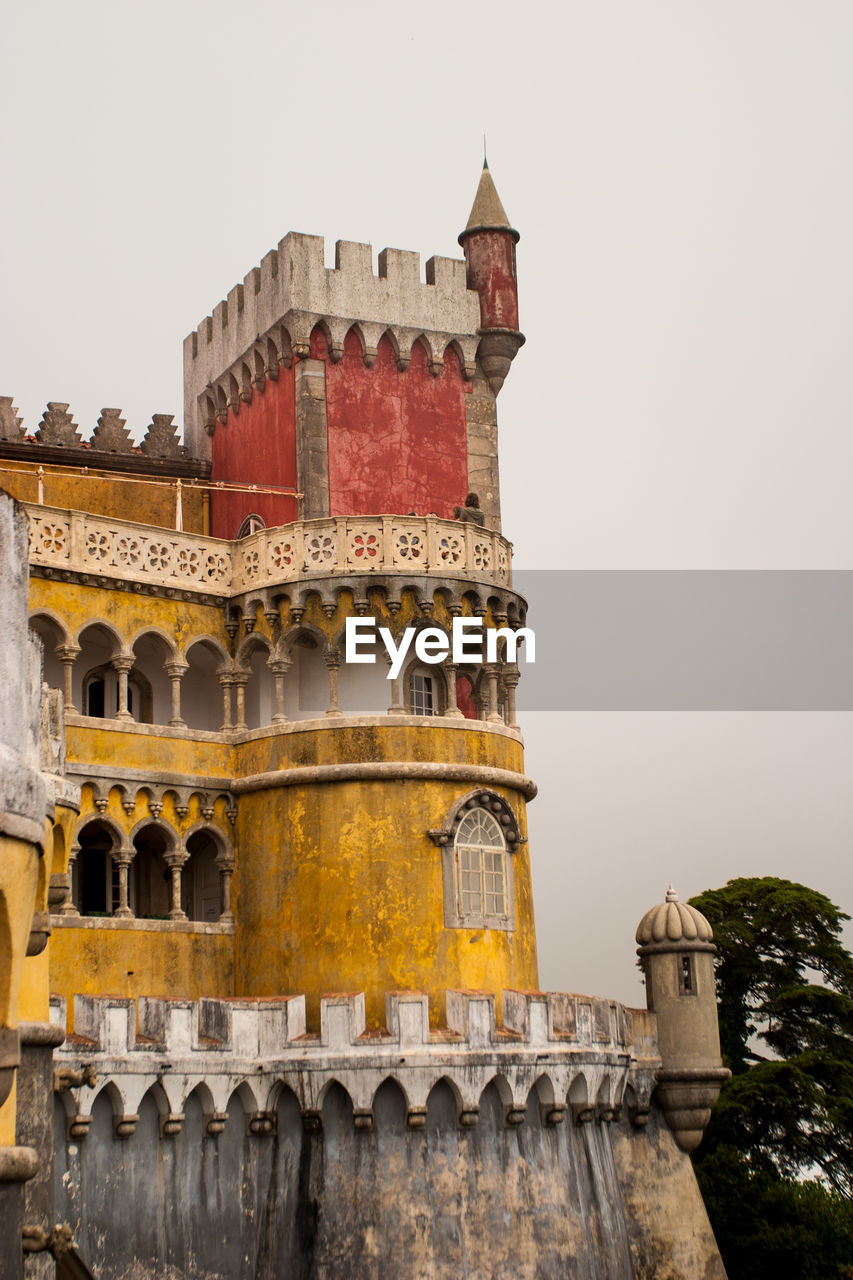 Low angle view of pena national palace against clear sky