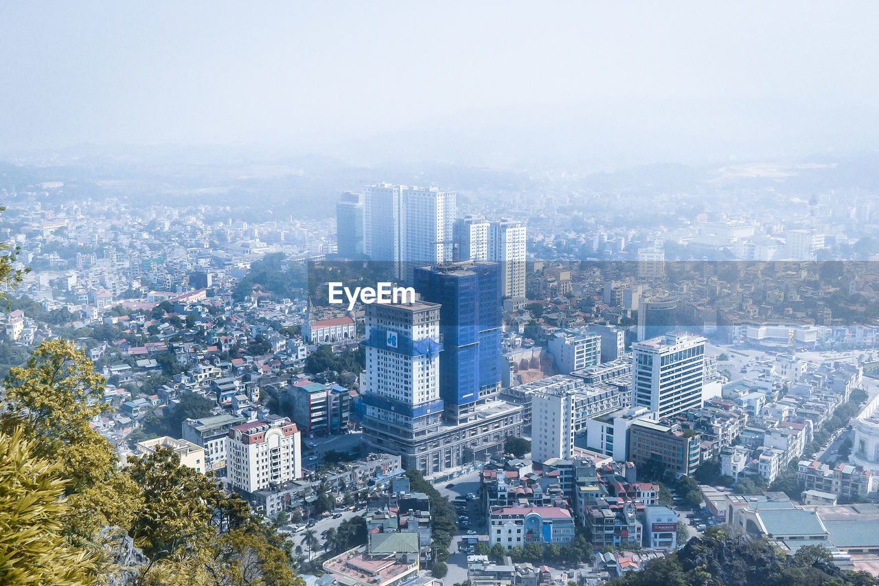 High angle view of buildings in city against sky