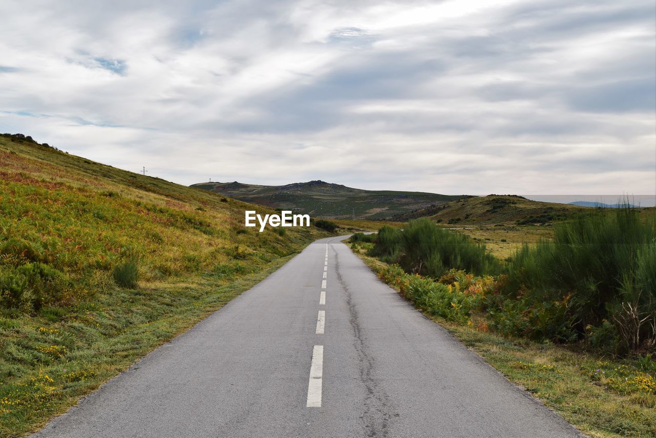 Empty road along countryside landscape