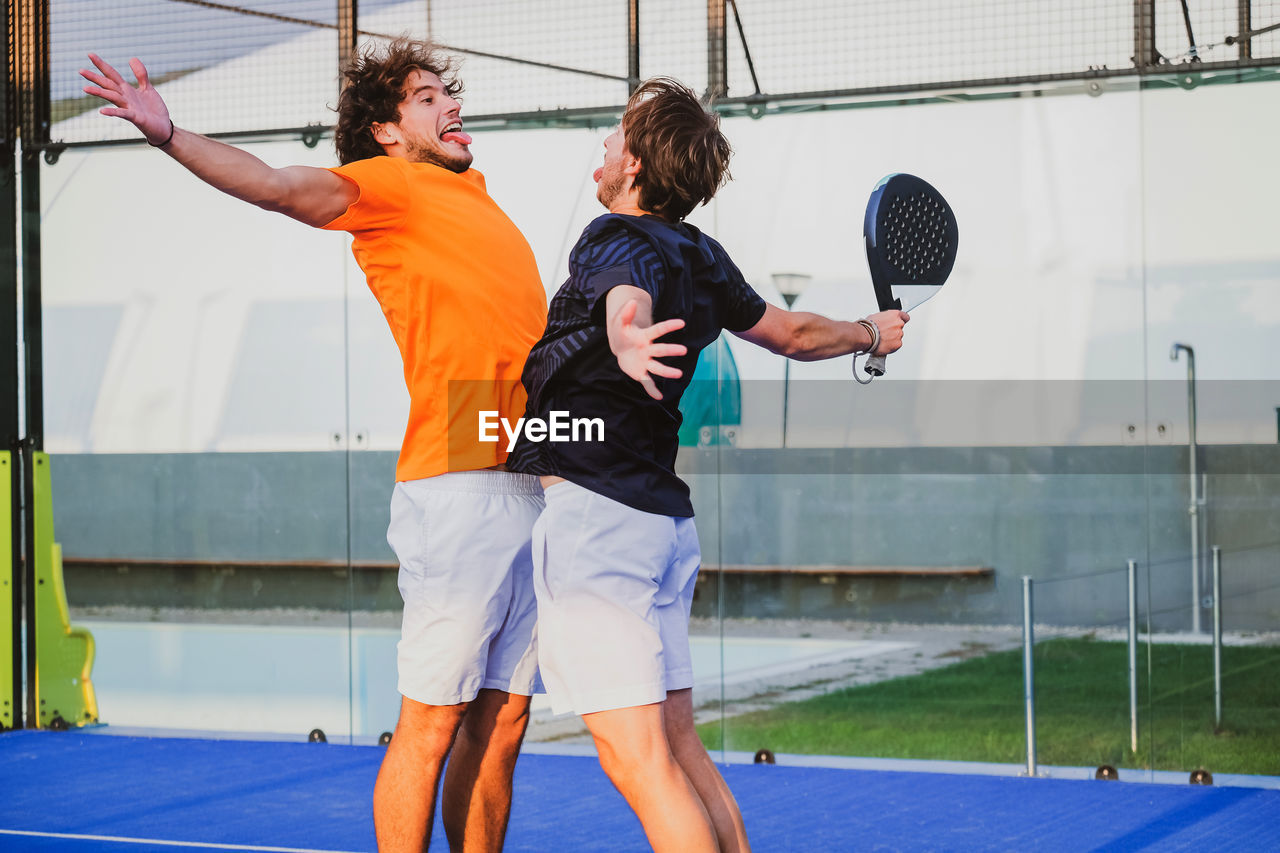 full length of young man playing tennis