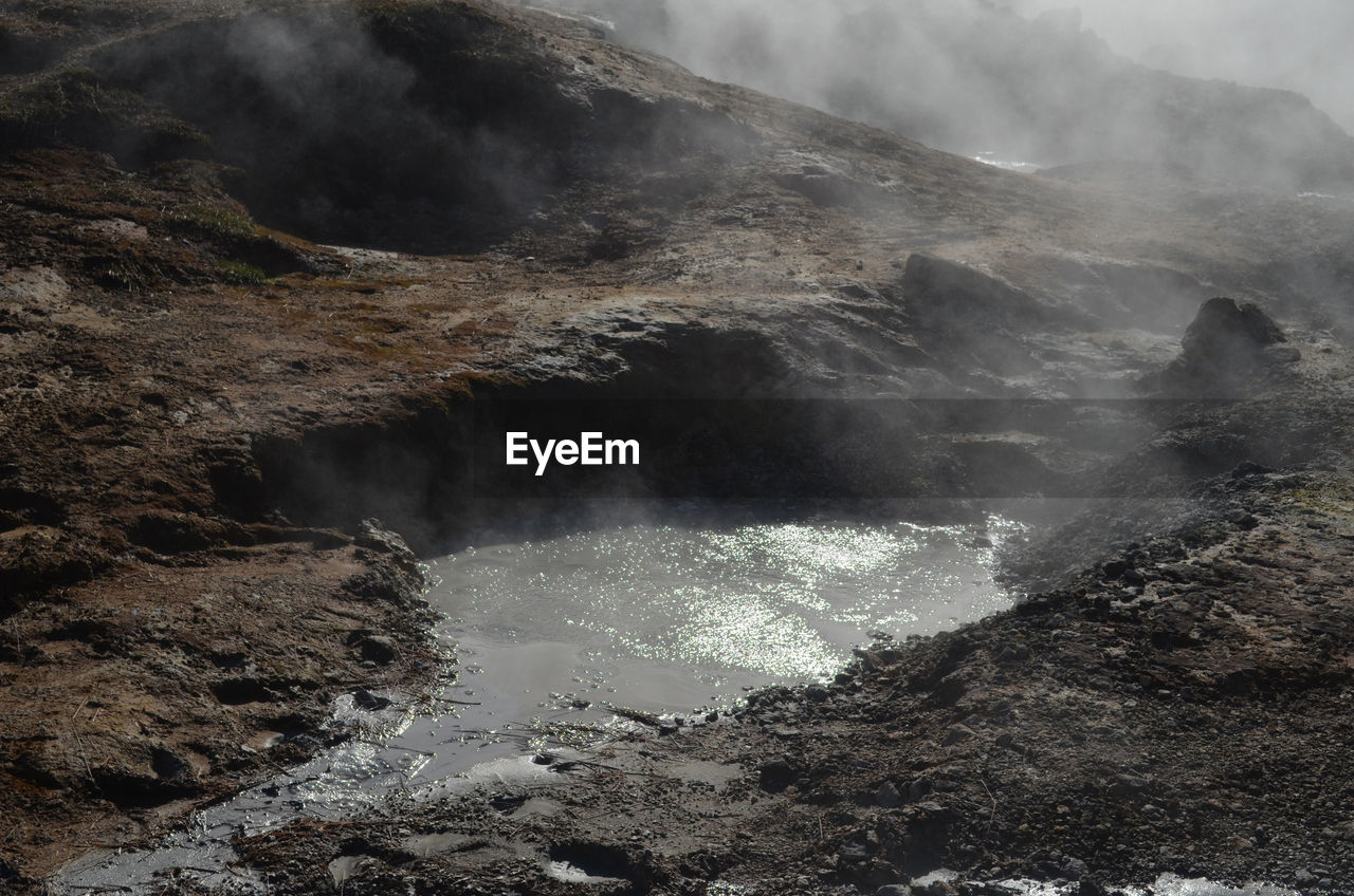 Boiling, bubbling and steaming mud in a volcanic landscape.