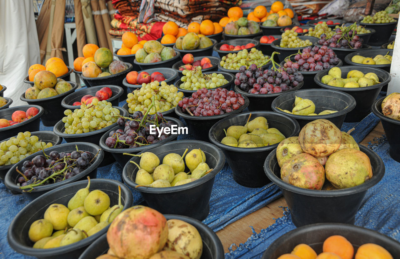 HIGH ANGLE VIEW OF VARIOUS FRUITS FOR SALE AT MARKET