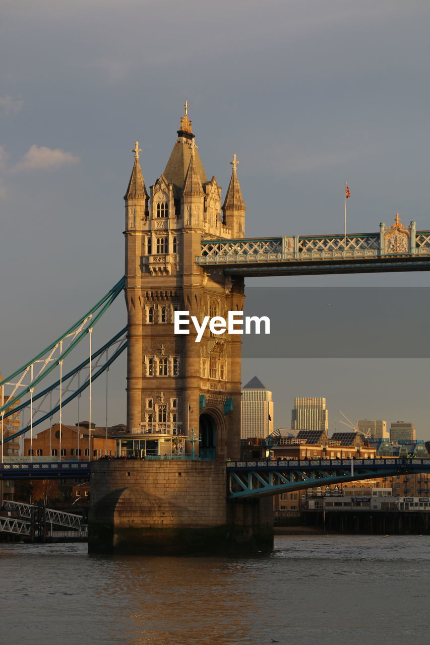 Bridge over river with city in background