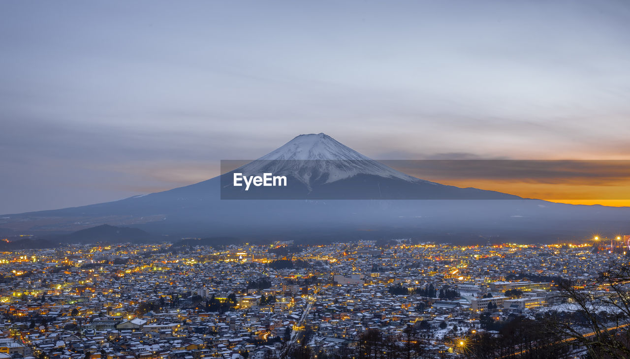 Aerial view of cityscape against mountain