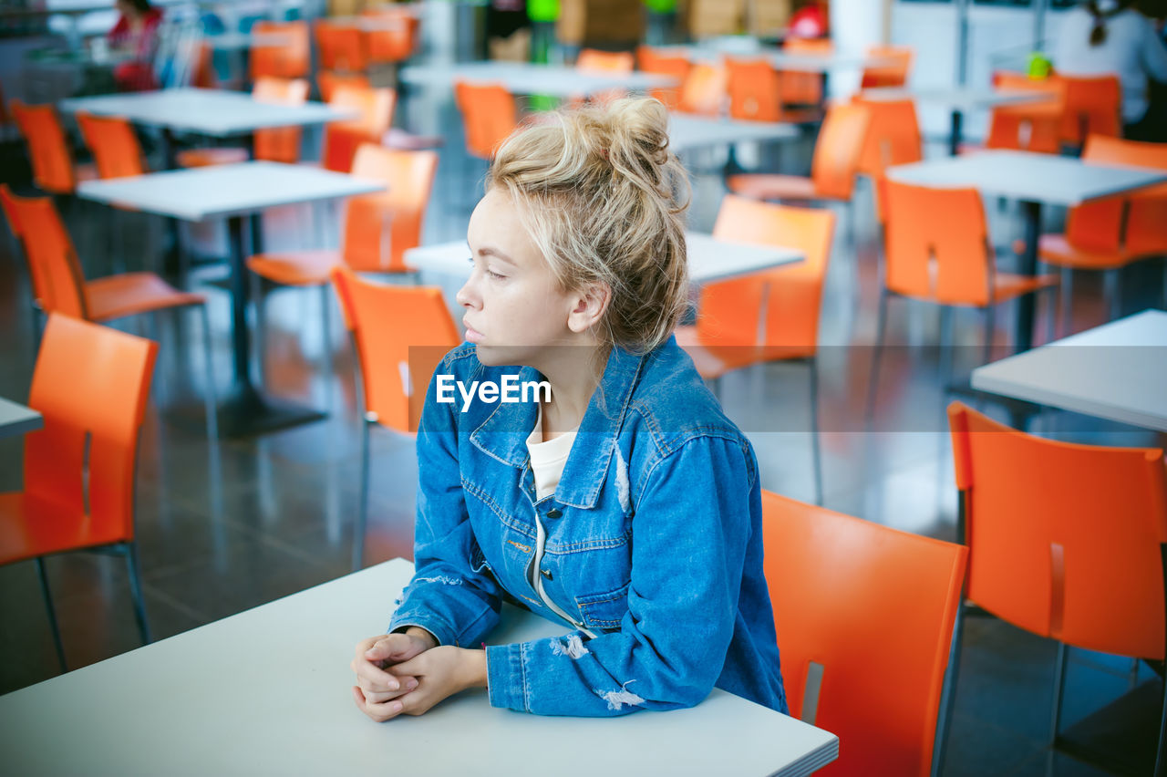 Woman sitting on chair in supermarket