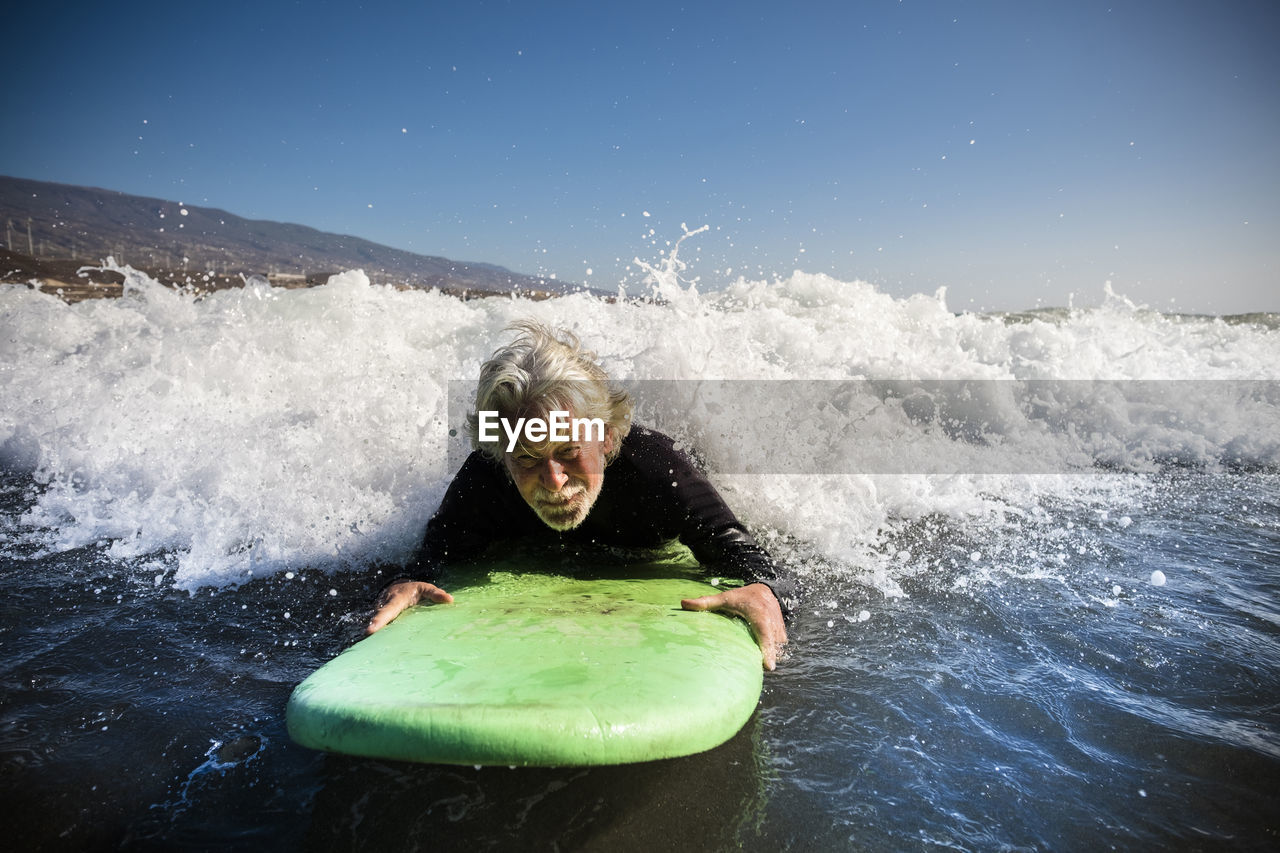 MAN SPLASHING IN SEA