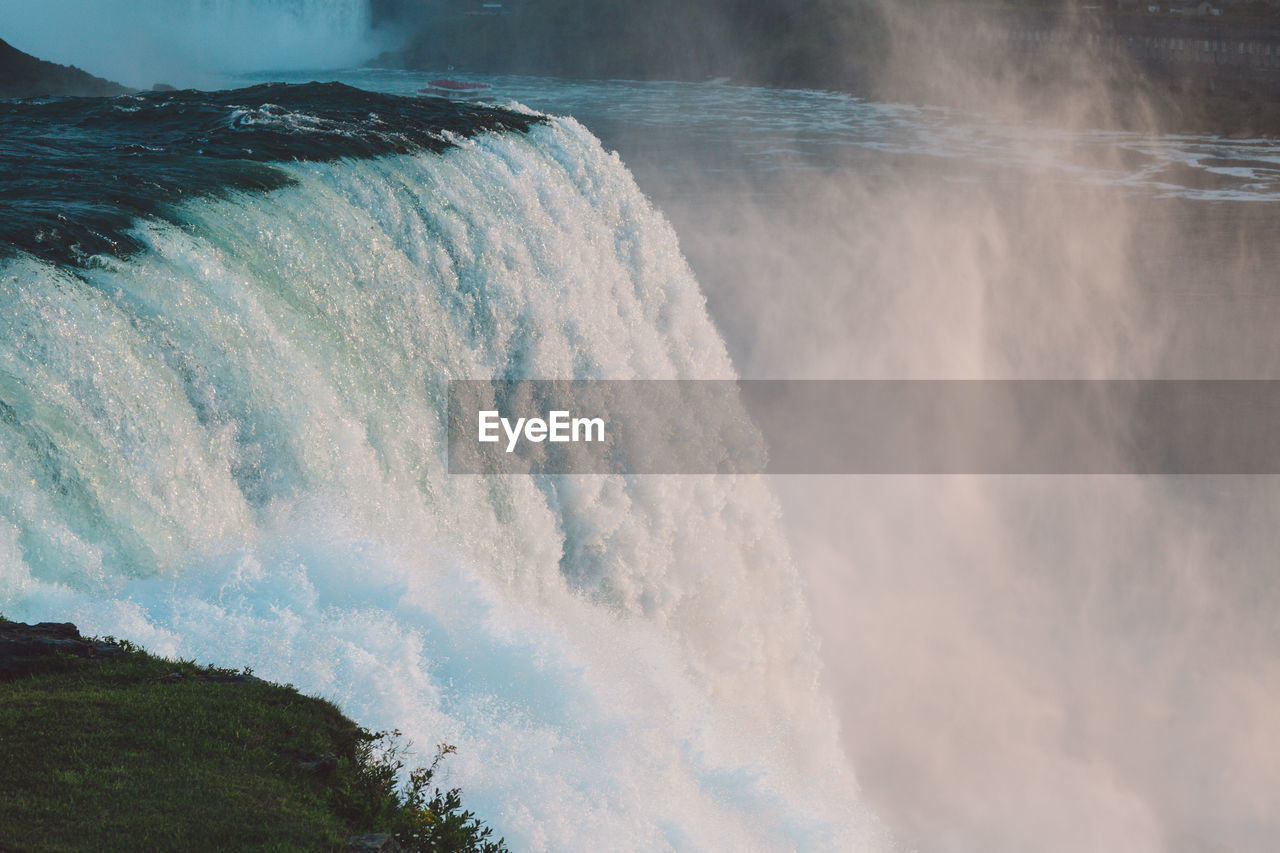 Scenic view of waterfall against sky