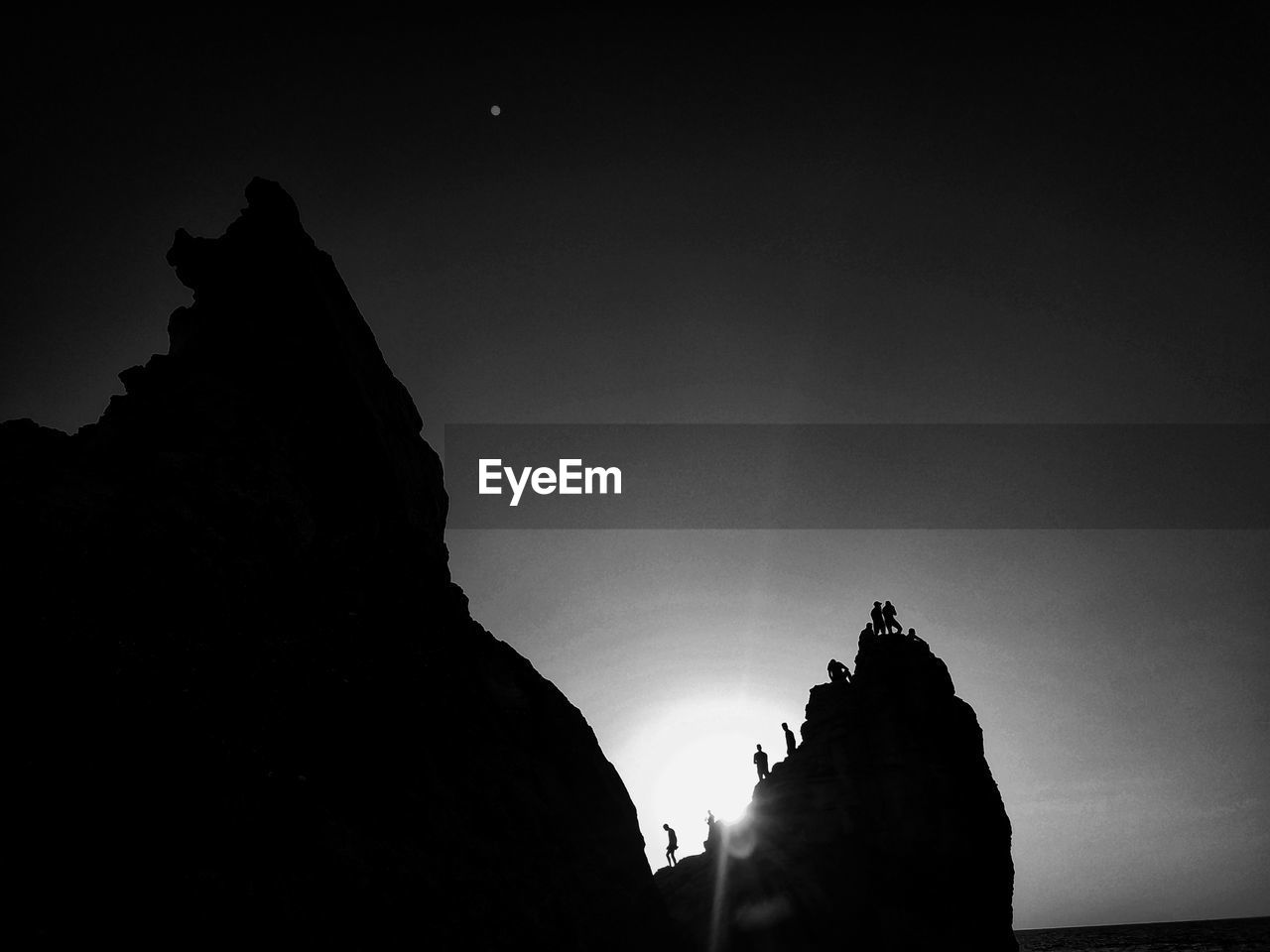 LOW ANGLE VIEW OF SILHOUETTE ROCK FORMATION AGAINST SKY