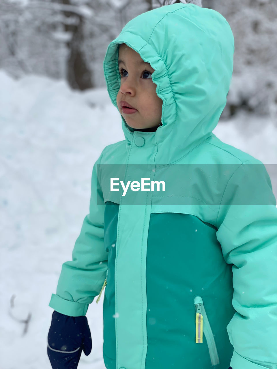 Portrait of boy standing on snow