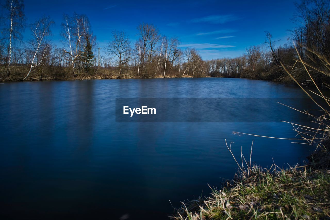 Scenic view of lake against blue sky