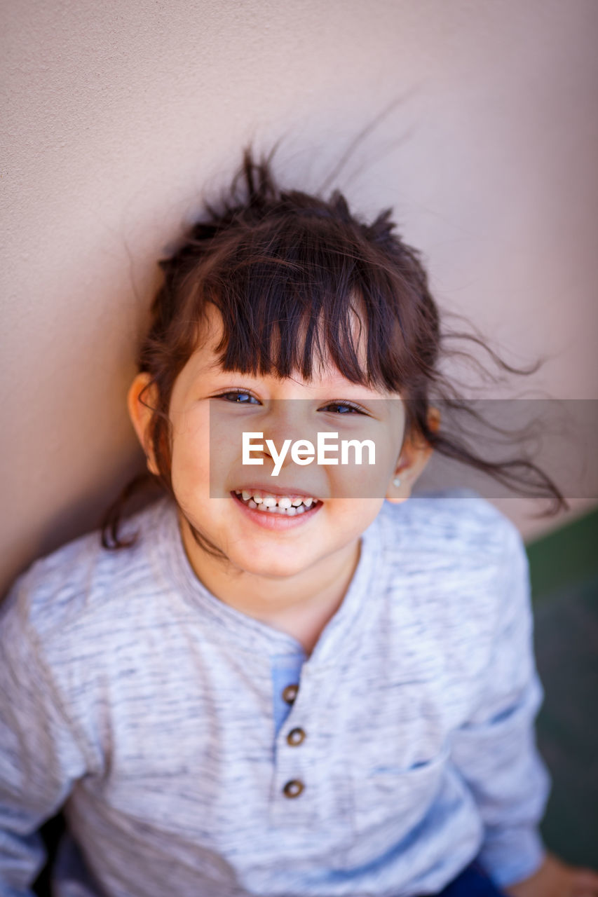 Portrait of smiling girl with tousled hair