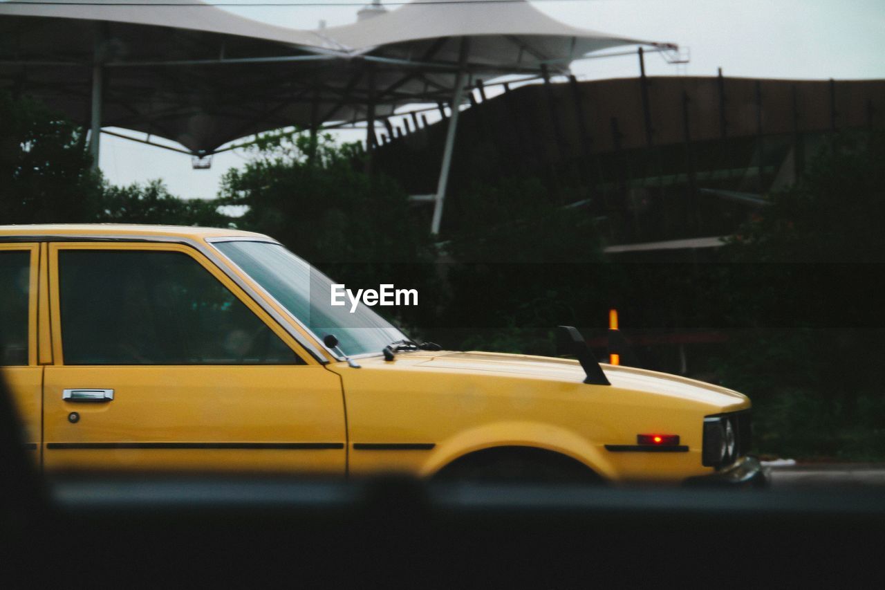 Yellow car seen from window