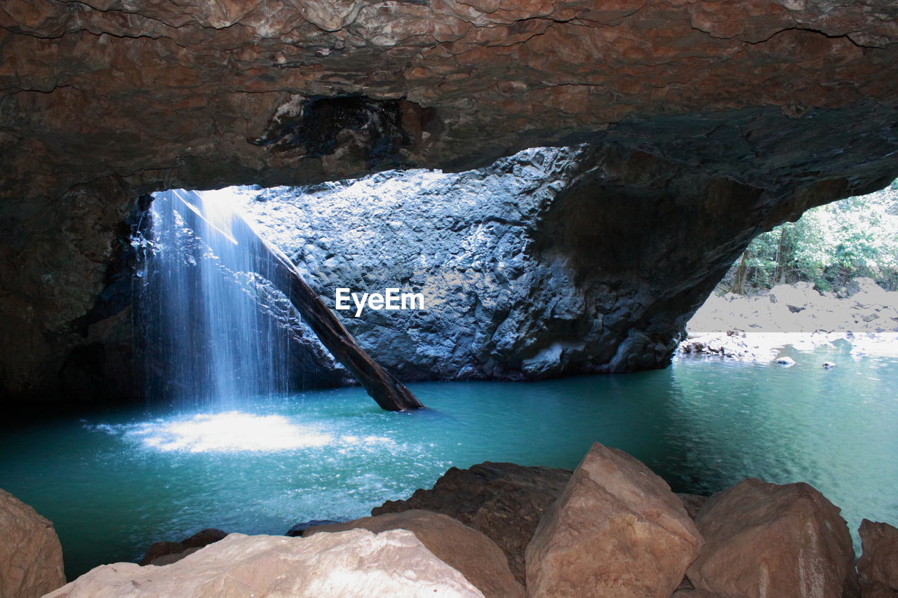 SCENIC VIEW OF WATERFALL AT CAVE