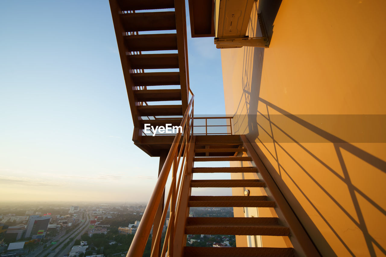LOW ANGLE VIEW OF STAIRCASE AGAINST SKY