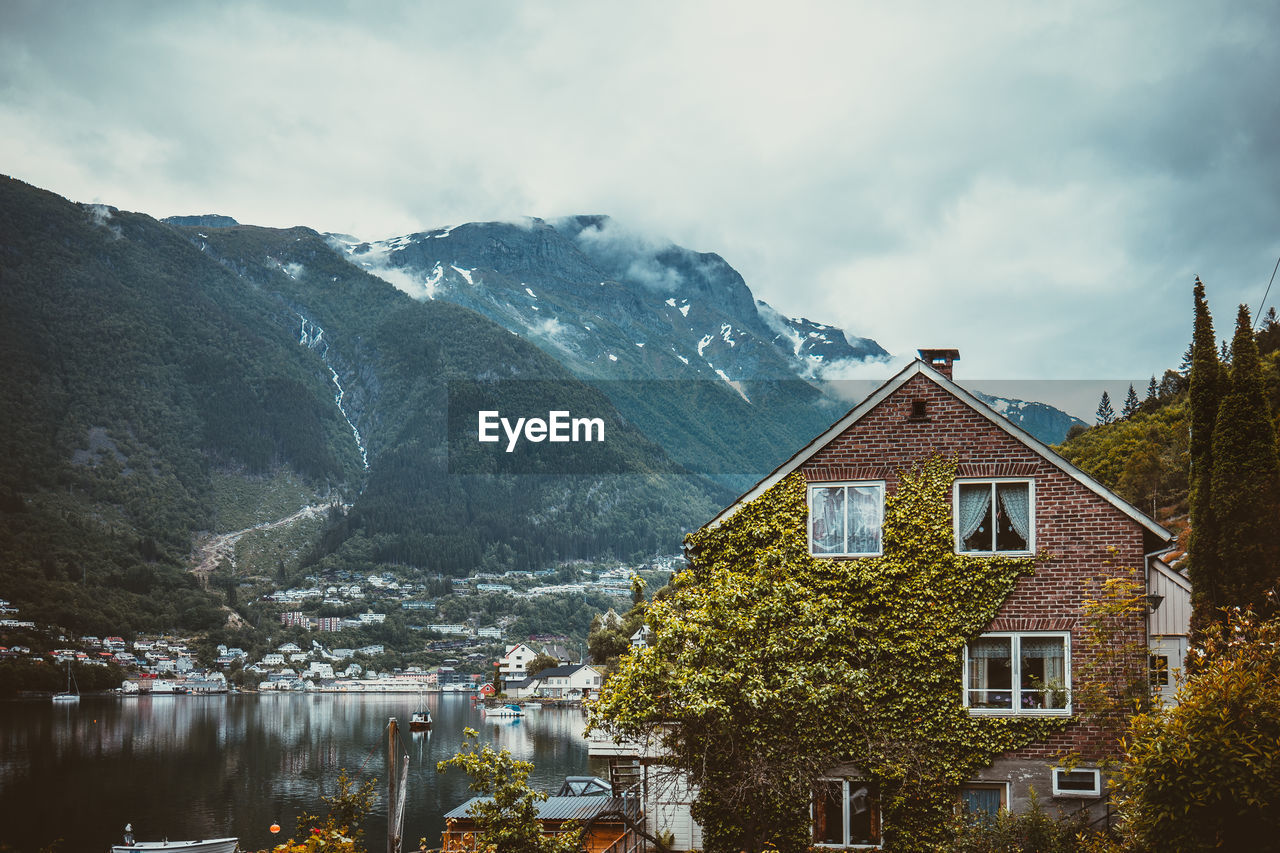 BUILDINGS AGAINST MOUNTAIN RANGE AGAINST SKY