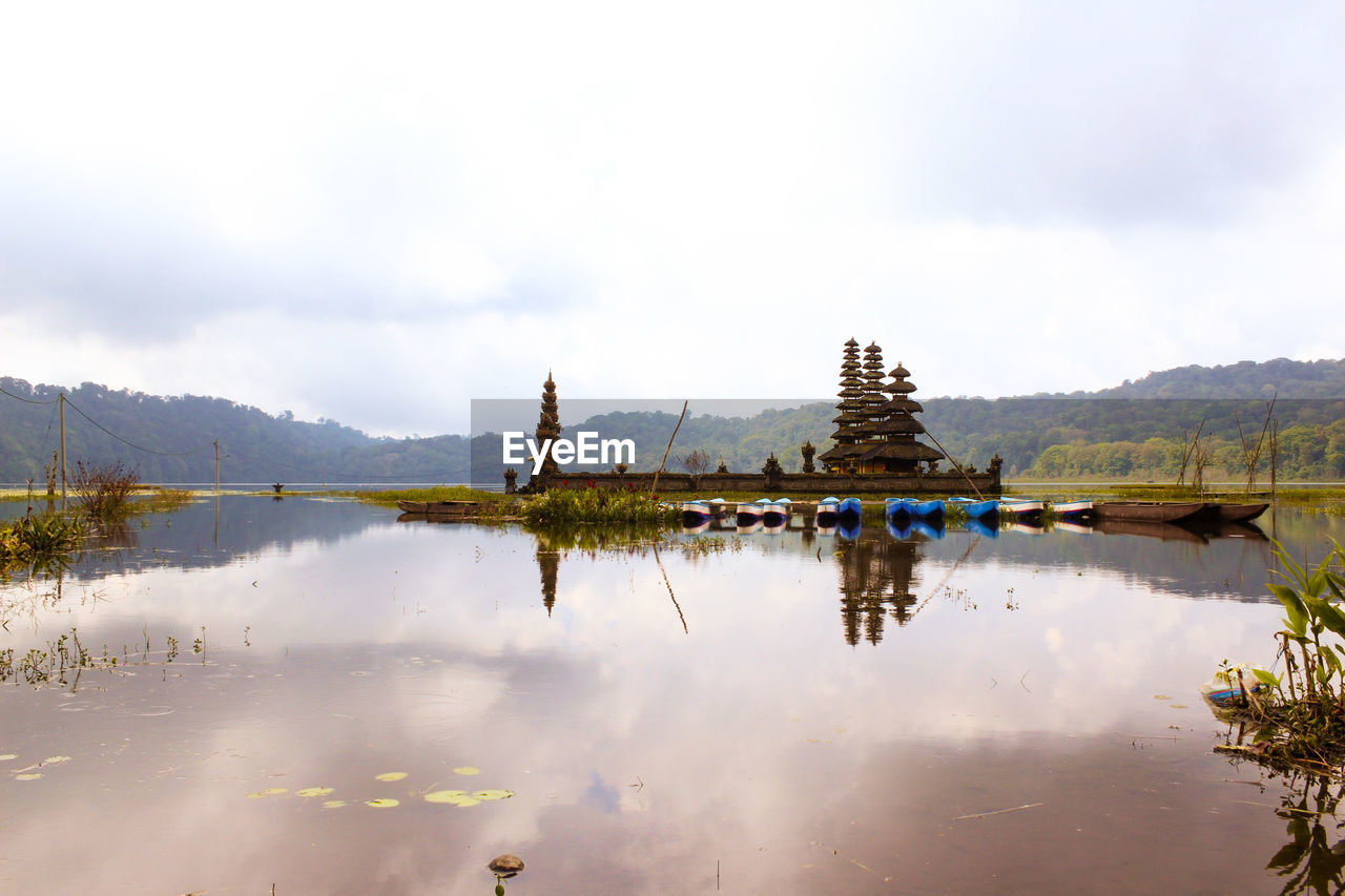 Panoramic view of lake by buildings against sky