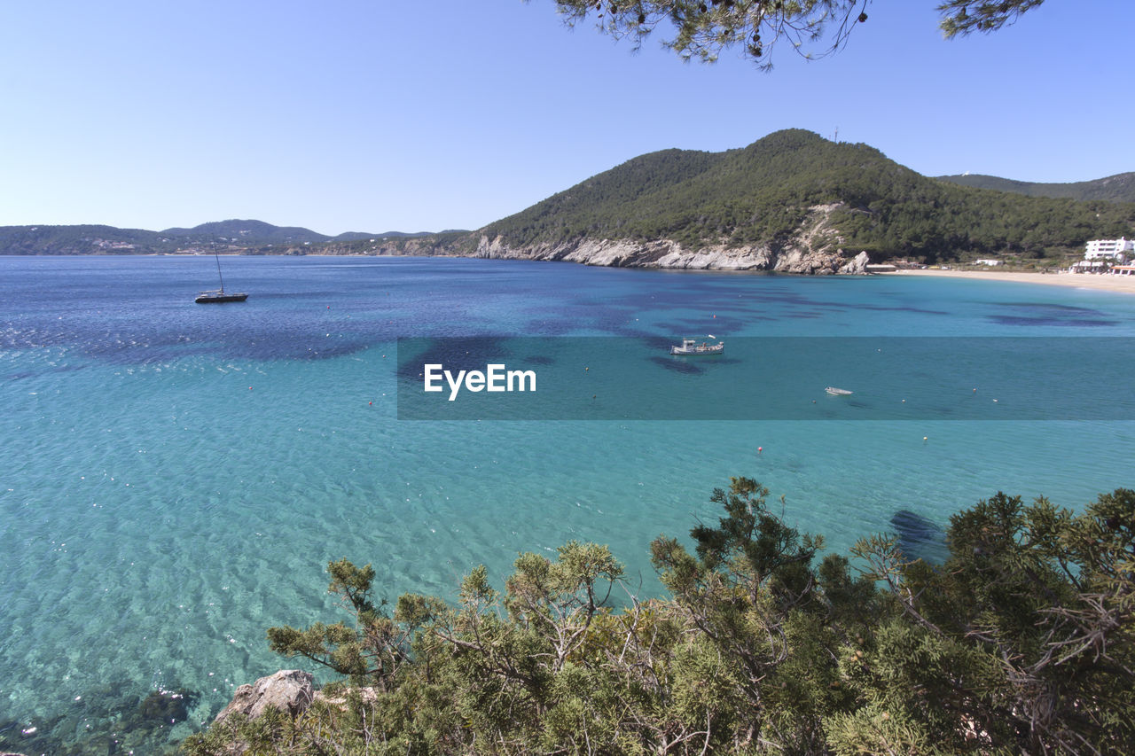 Motor boats in sea on sunny day