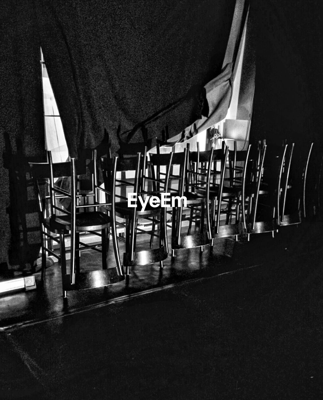 View of empty chairs and tables at night