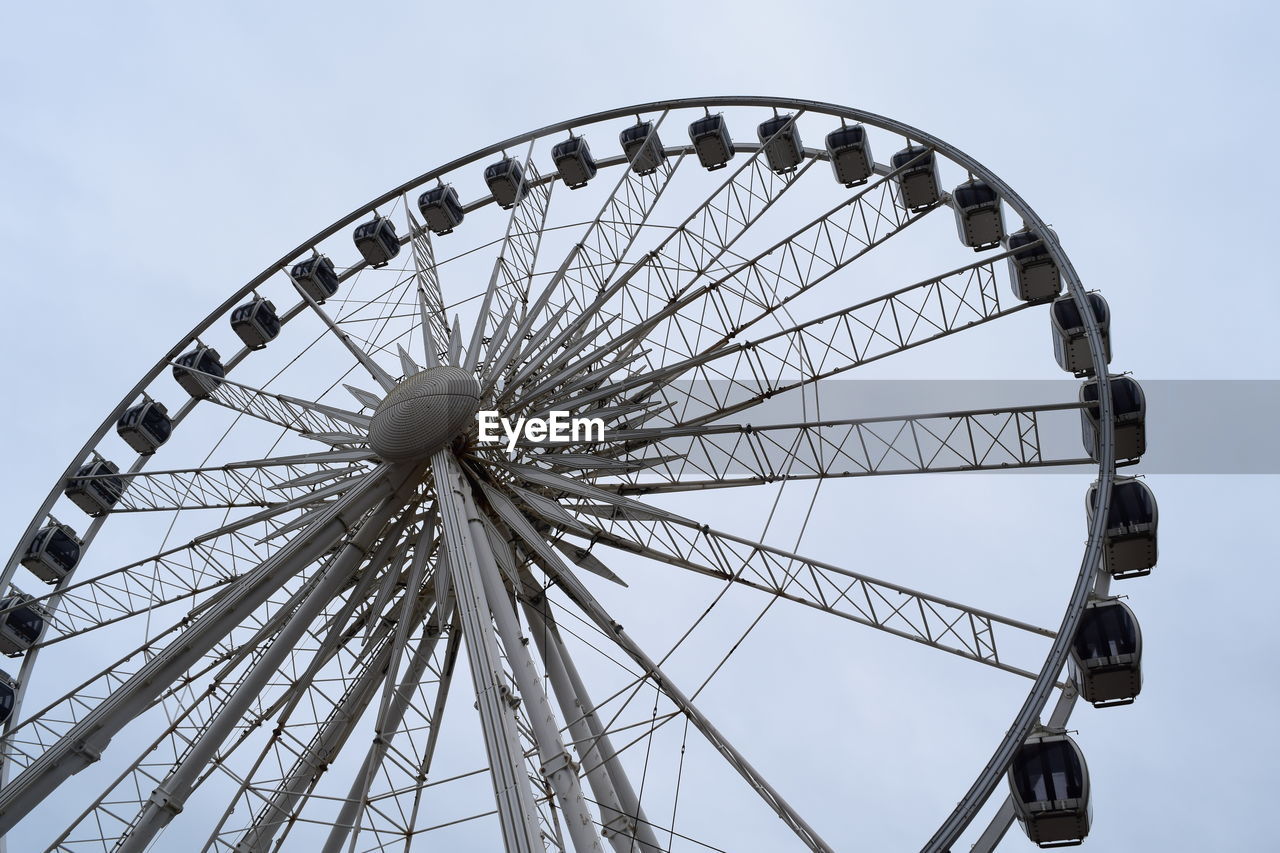 Low angle view of ferris wheel against sky