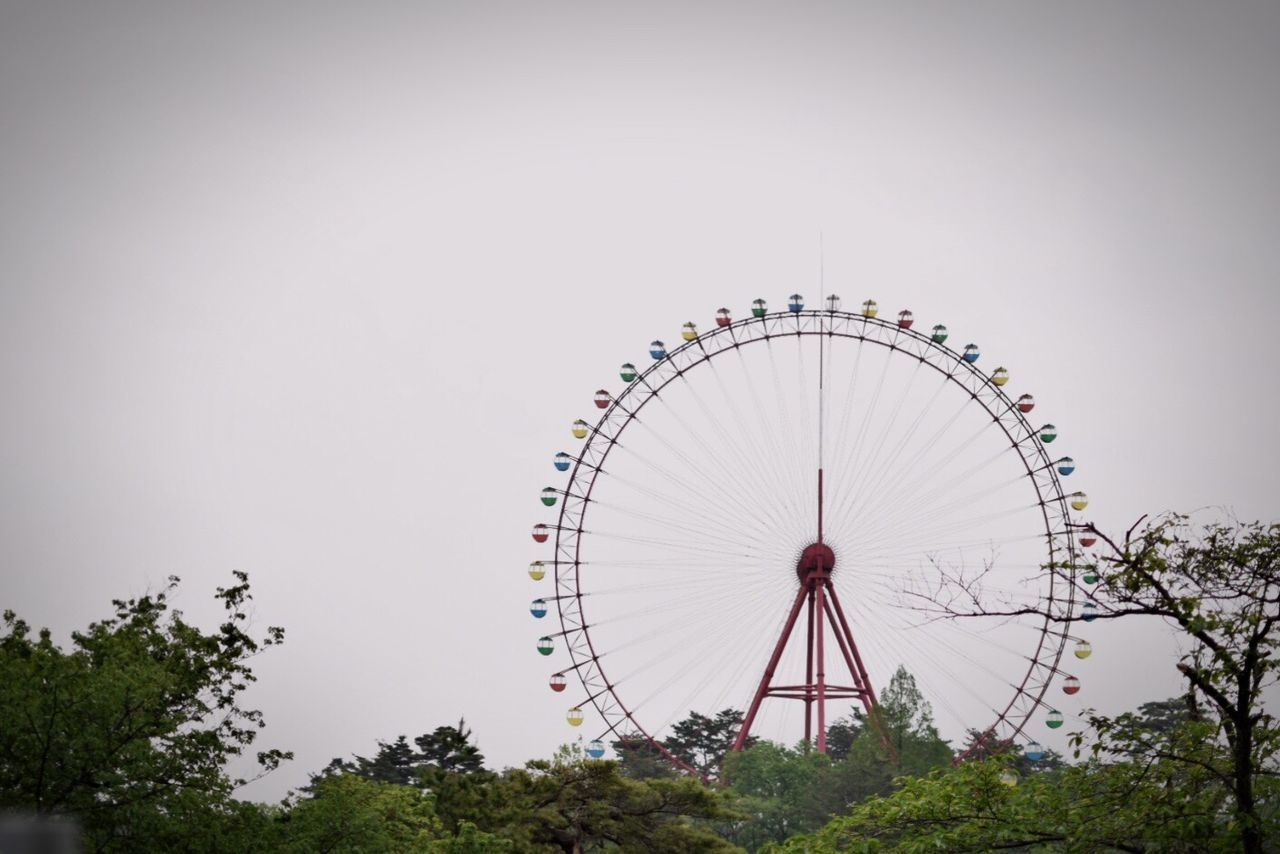 Low angle view of ferris wheel against clear sky