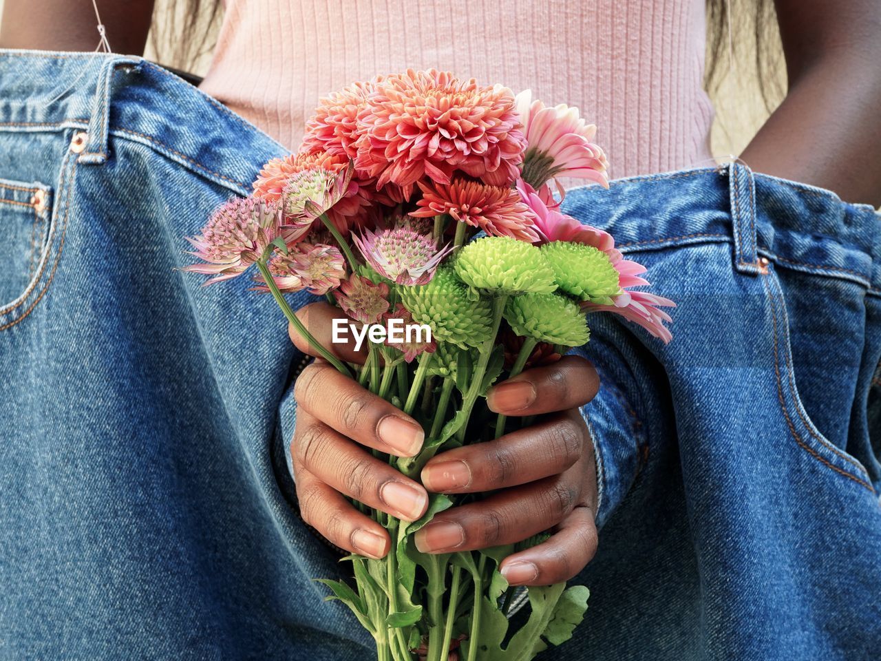 Midsection of woman holding flower bouquet