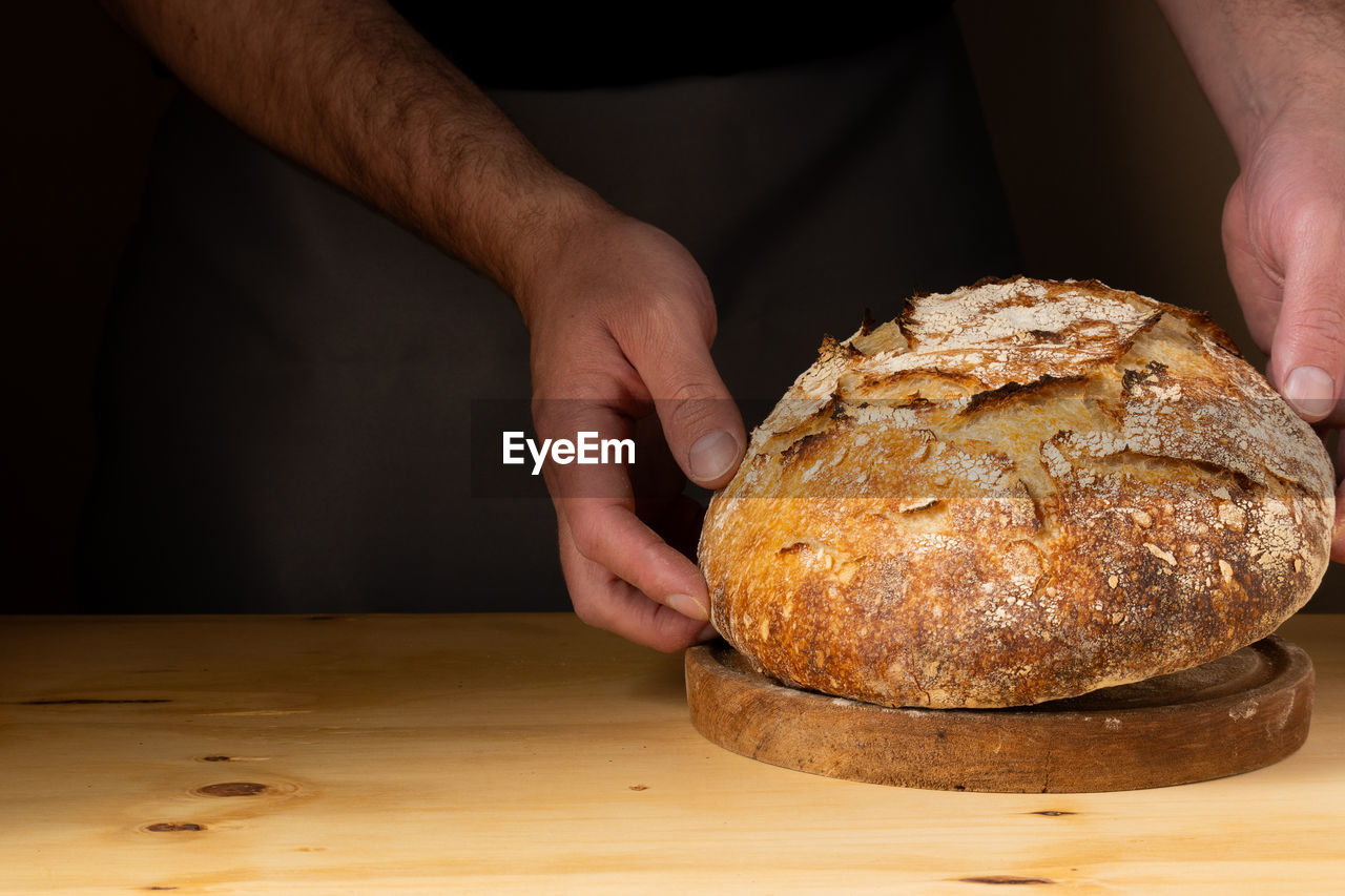 cropped hand of person preparing food on table