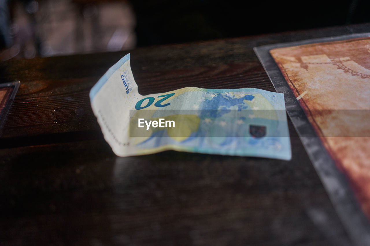 Close-up of paper currency on wooden table