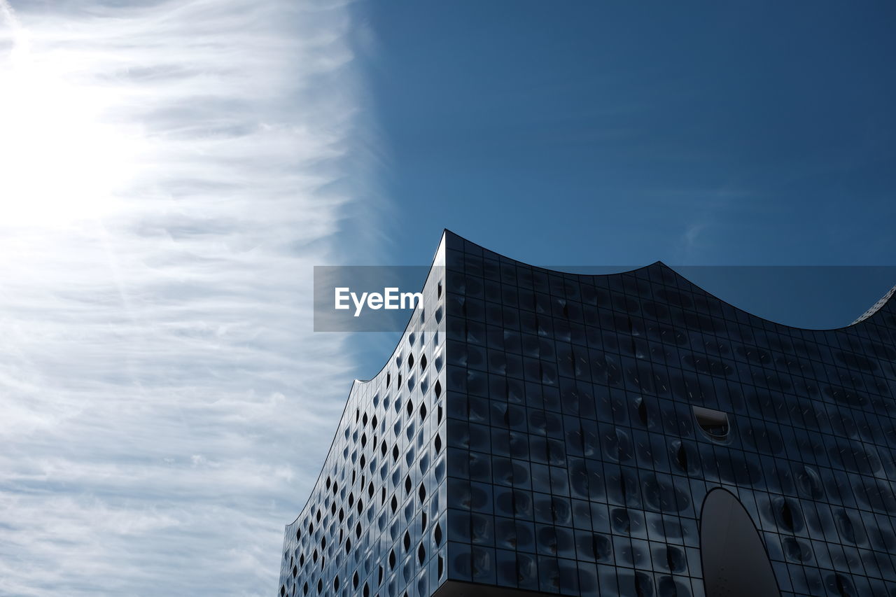 Low angle view of modern office building against sky