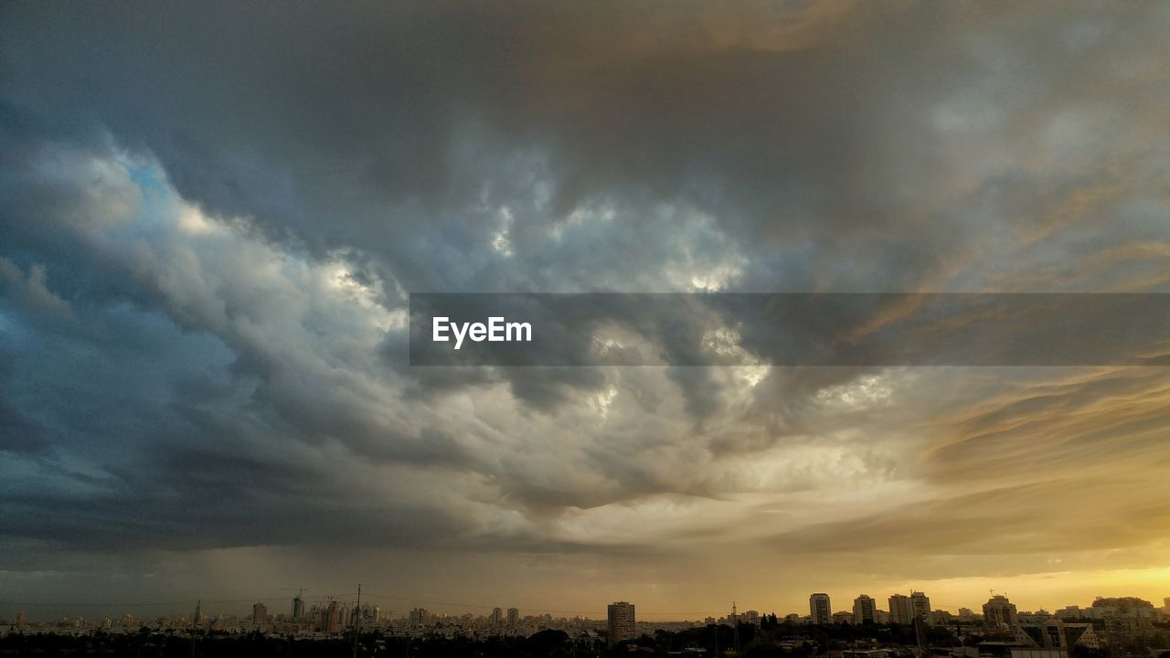 STORM CLOUDS OVER CITYSCAPE