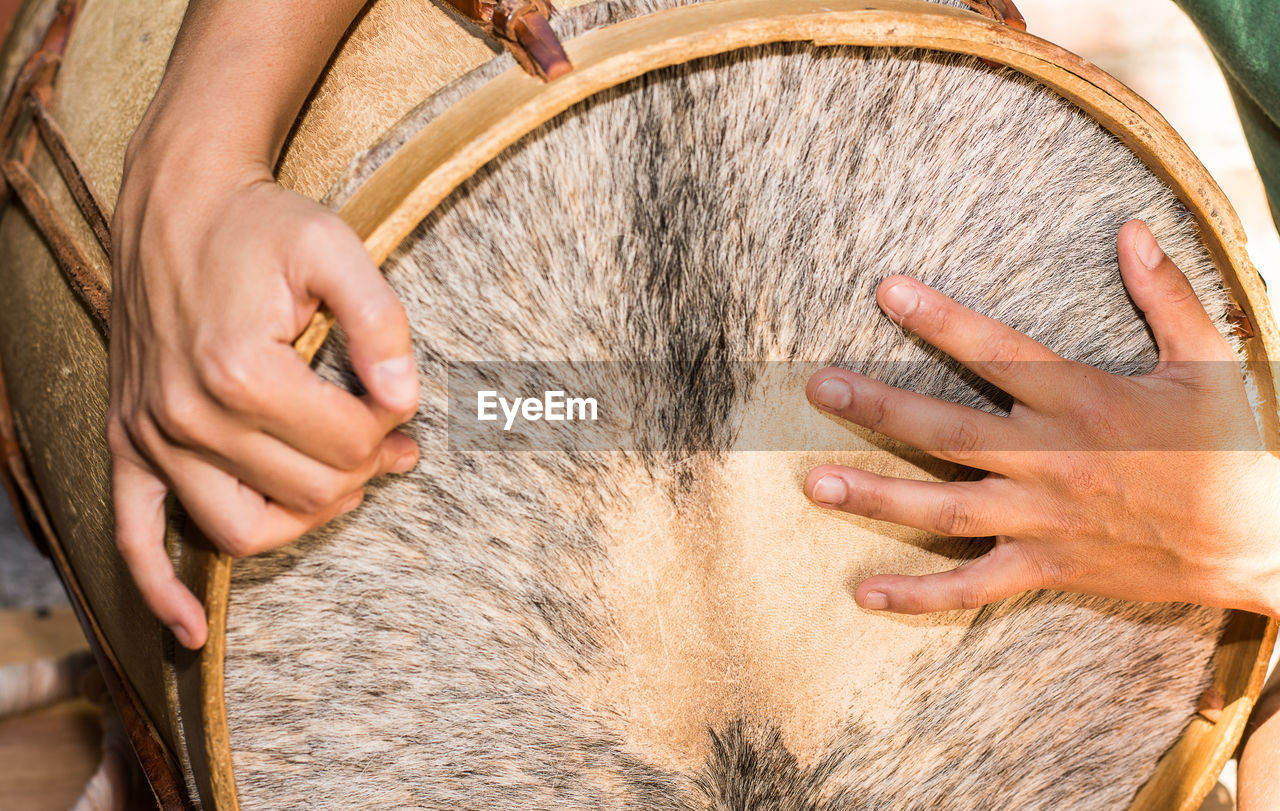 Close-up of hand playing drums