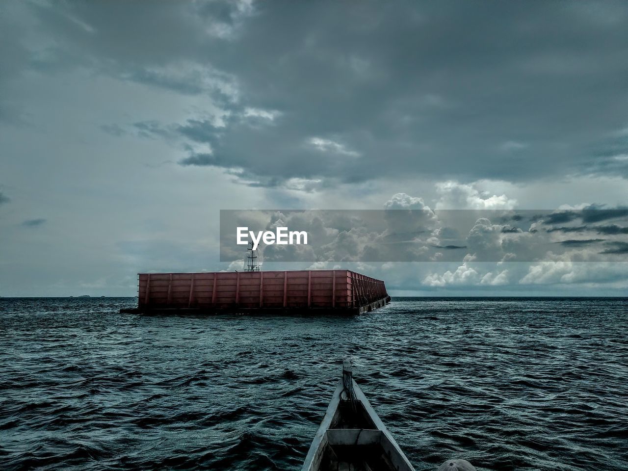 Ship floating on sea against sky