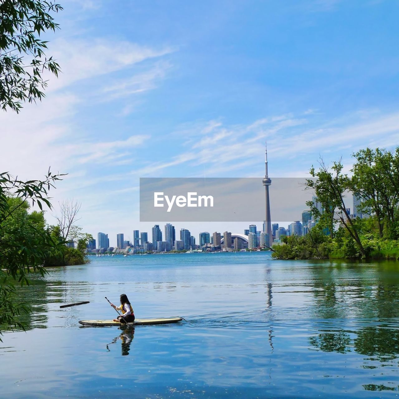 PEOPLE IN RIVER AGAINST SKY