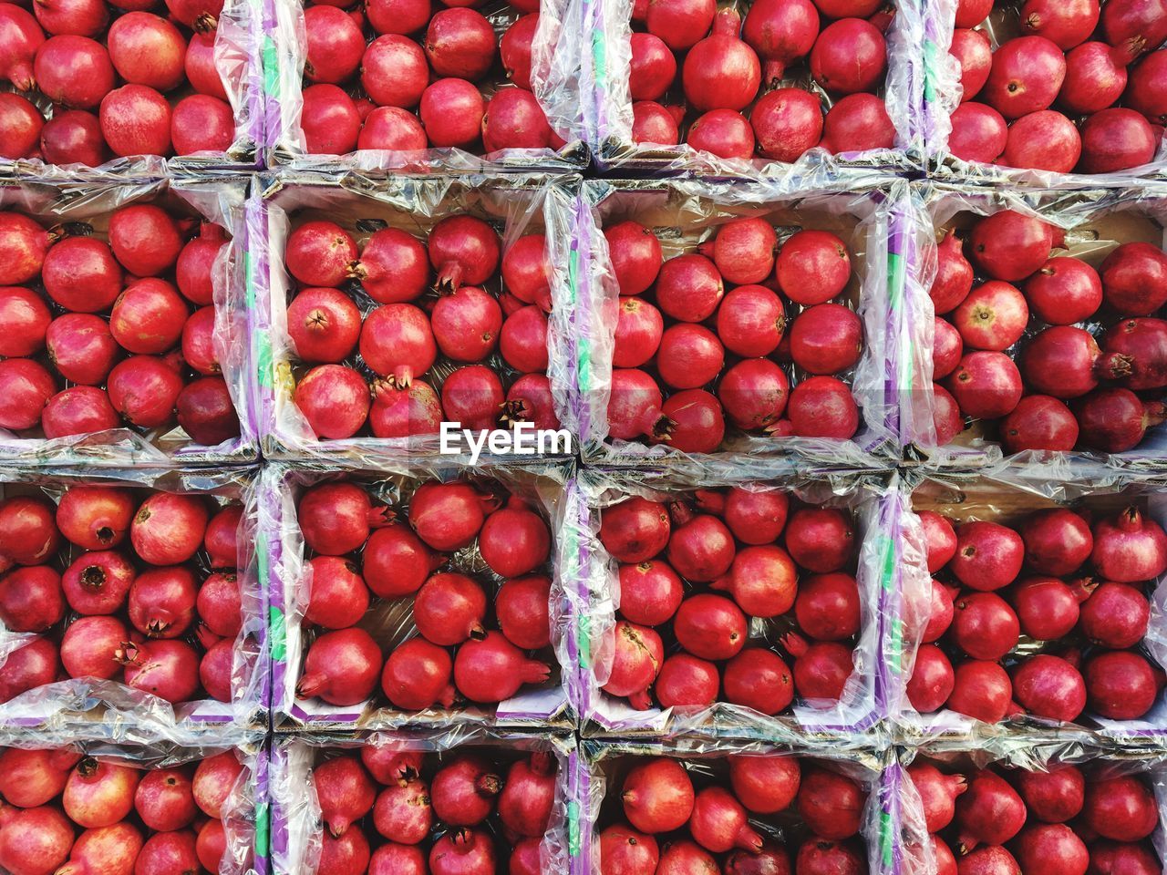 Full frame shot of pomegranates in containers at market for sale