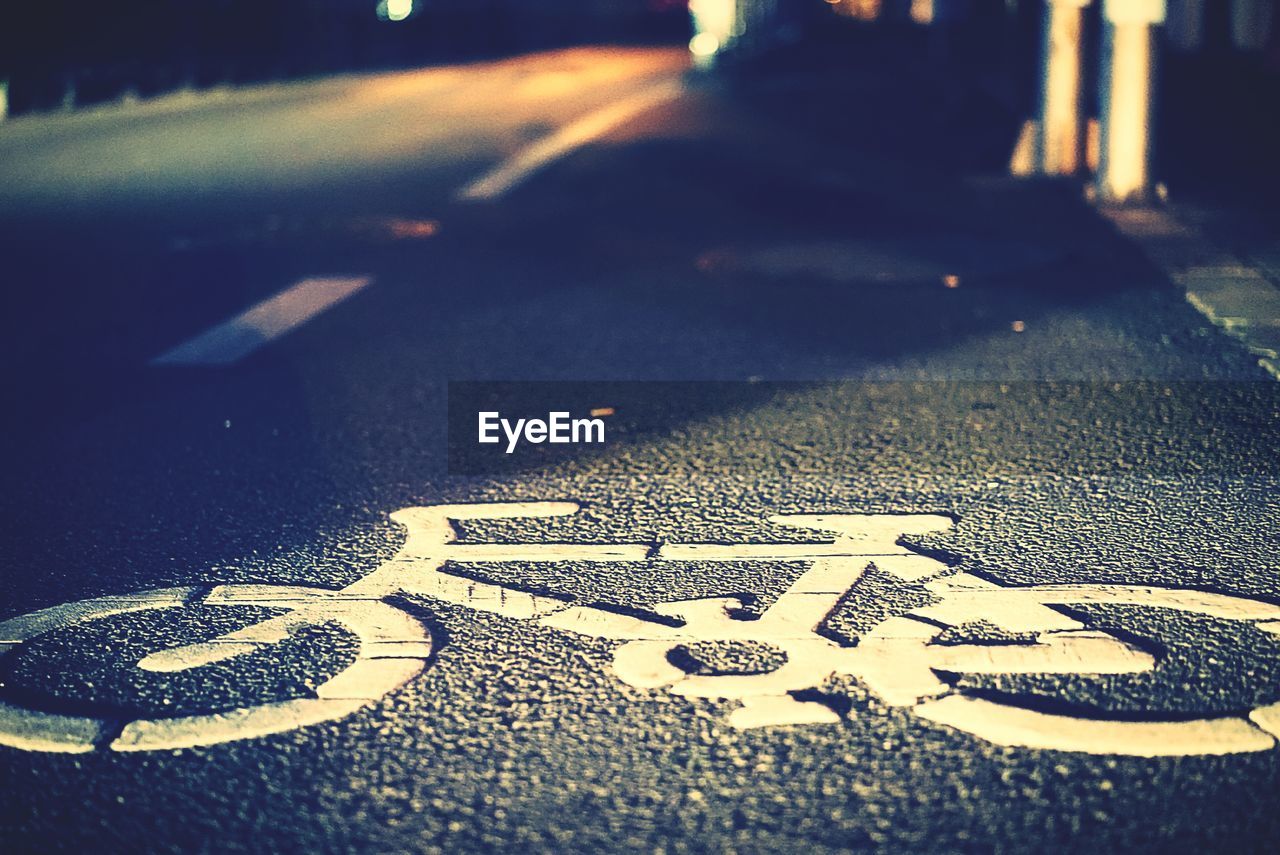 Bicycle lane sign on road at night