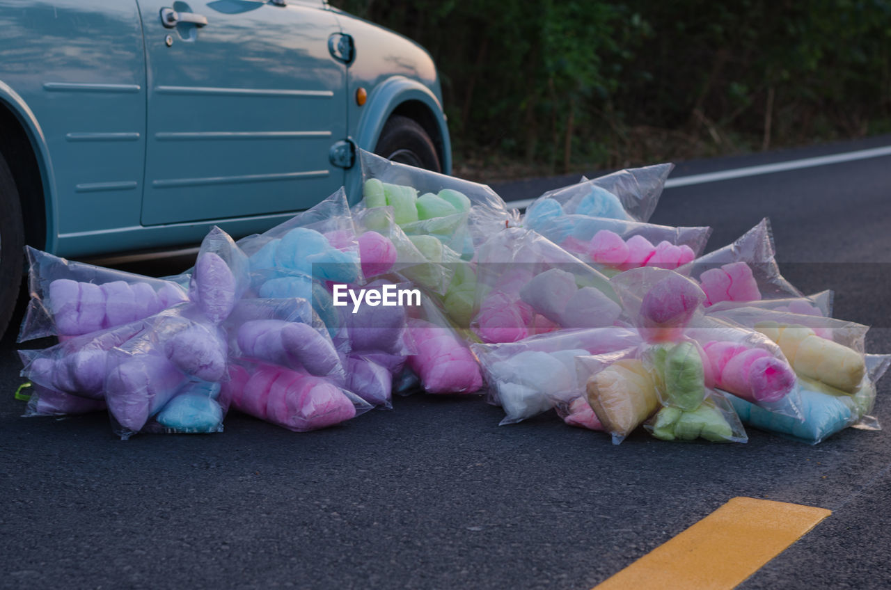 Close-up of multi colored cotton candies on road