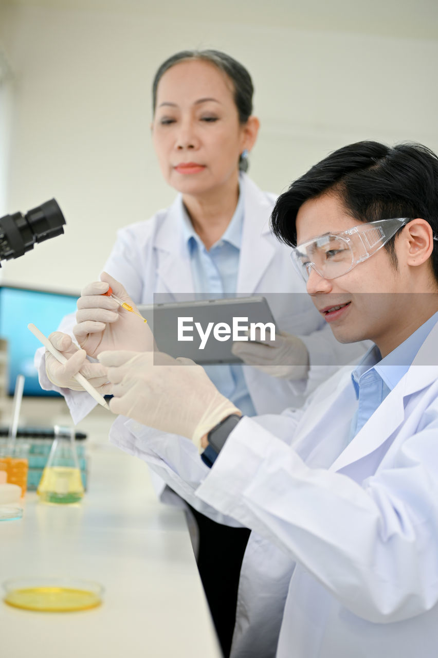 portrait of female doctor examining patient in laboratory