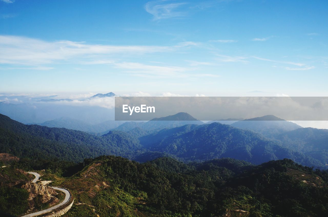 Scenic view of mountains against cloudy sky