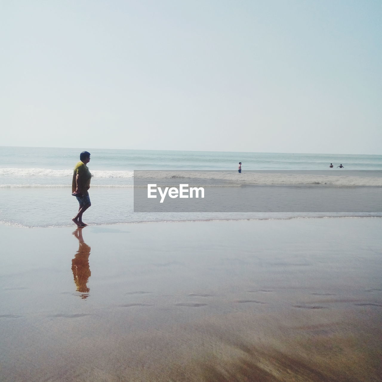 Full length of senior woman walking on shore at beach