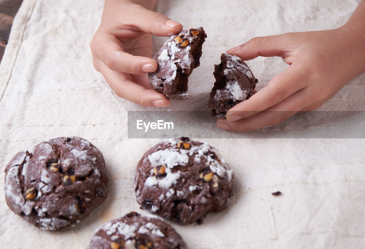 Cropped hands holding cookies