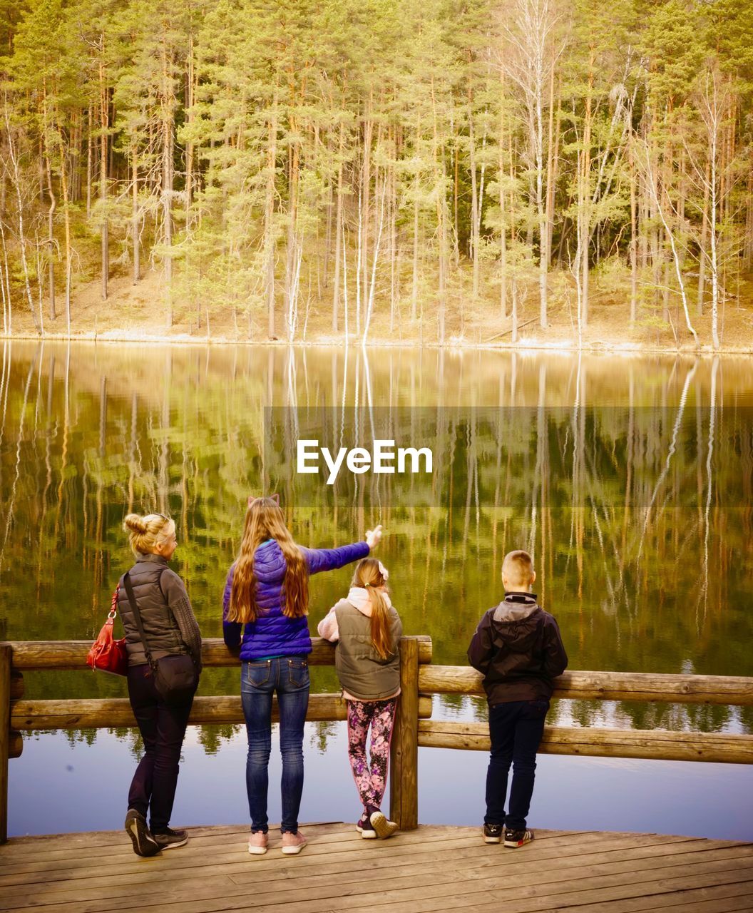 Full length of people standing by lake